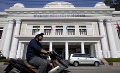 A motorcyclist rides past the Ho Chi Minh City stock exchange, one of Asia's best-performing markets this year. (Bloomberg Photo)