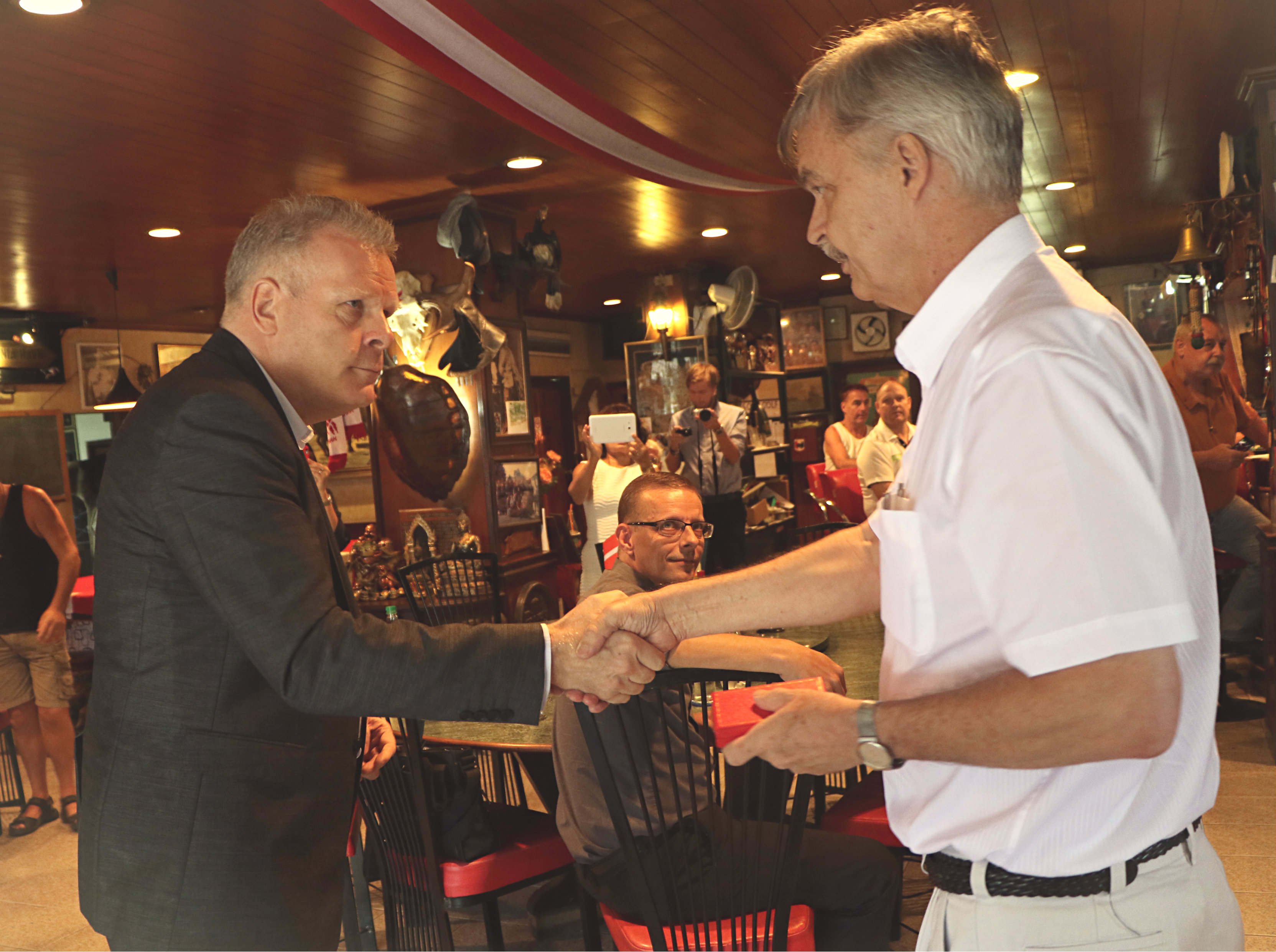 The Danish Ambassador Mikael Hemniti Winther presents Stig Vagt-Andersen with the Order of the Dannebrog, Knight 1st Class, for his exceptional work as a Consul in Pattaya. Photo by Louise Bihl Frandsen