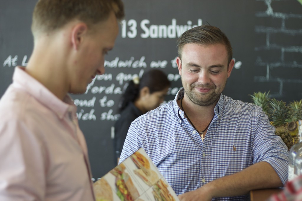 Daniel Baven (in front) and Mark Perthu-Hansen at the counter in Lucky 13 Sandwich in Patong. (Photo: Frederik Sonne)