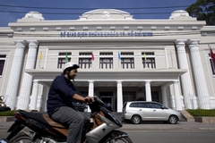 A motorcyclist rides past the Ho Chi Minh City stock exchange, one of Asia's best-performing markets this year. (Bloomberg Photo)