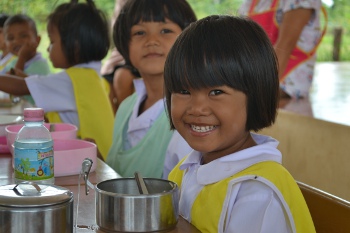 A girl enjoying her lunch at one of Periamma-supported schools in Surin