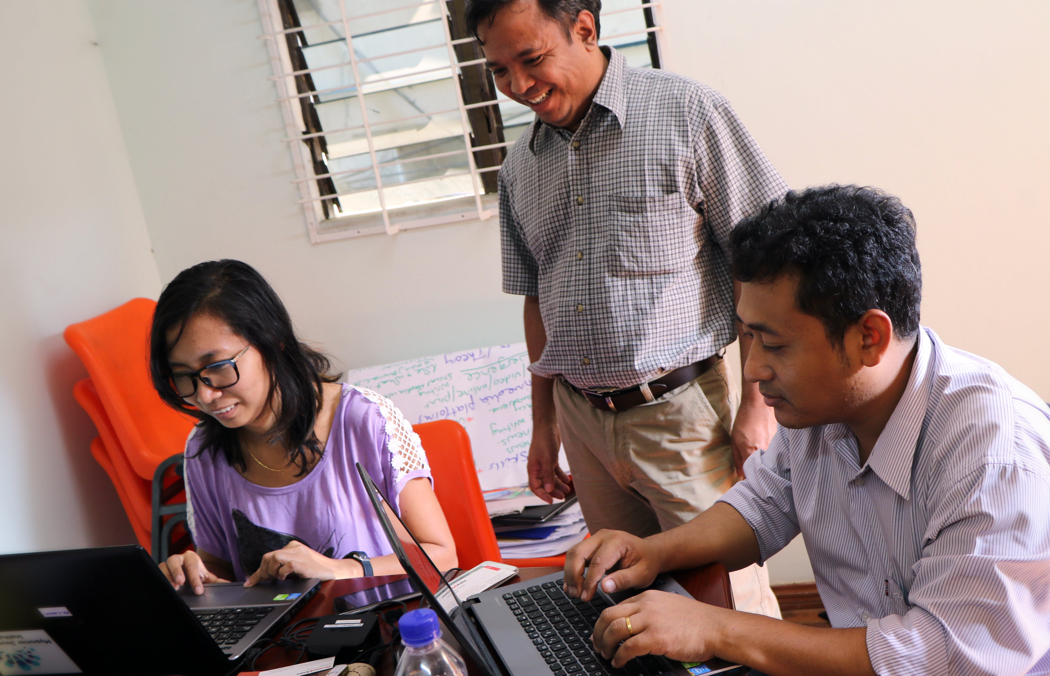 Training director at Myanmar Journalism Institute (MJI), Mr Siein Win and two of the local trainers at the institute in Yangon.