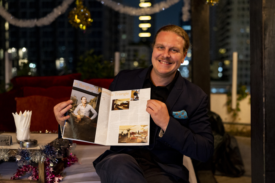 Johan Davidsson posing at Nest, holding up his previous front cover story in ScandAsia.