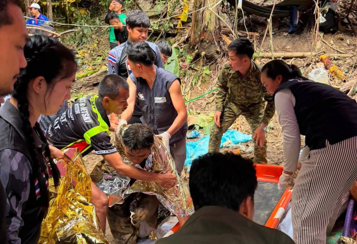 Five rescued from flooded Laos cave as search continues for two missing men