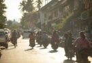 A group of people riding motorcycles down a street