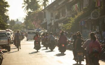 A group of people riding motorcycles down a street